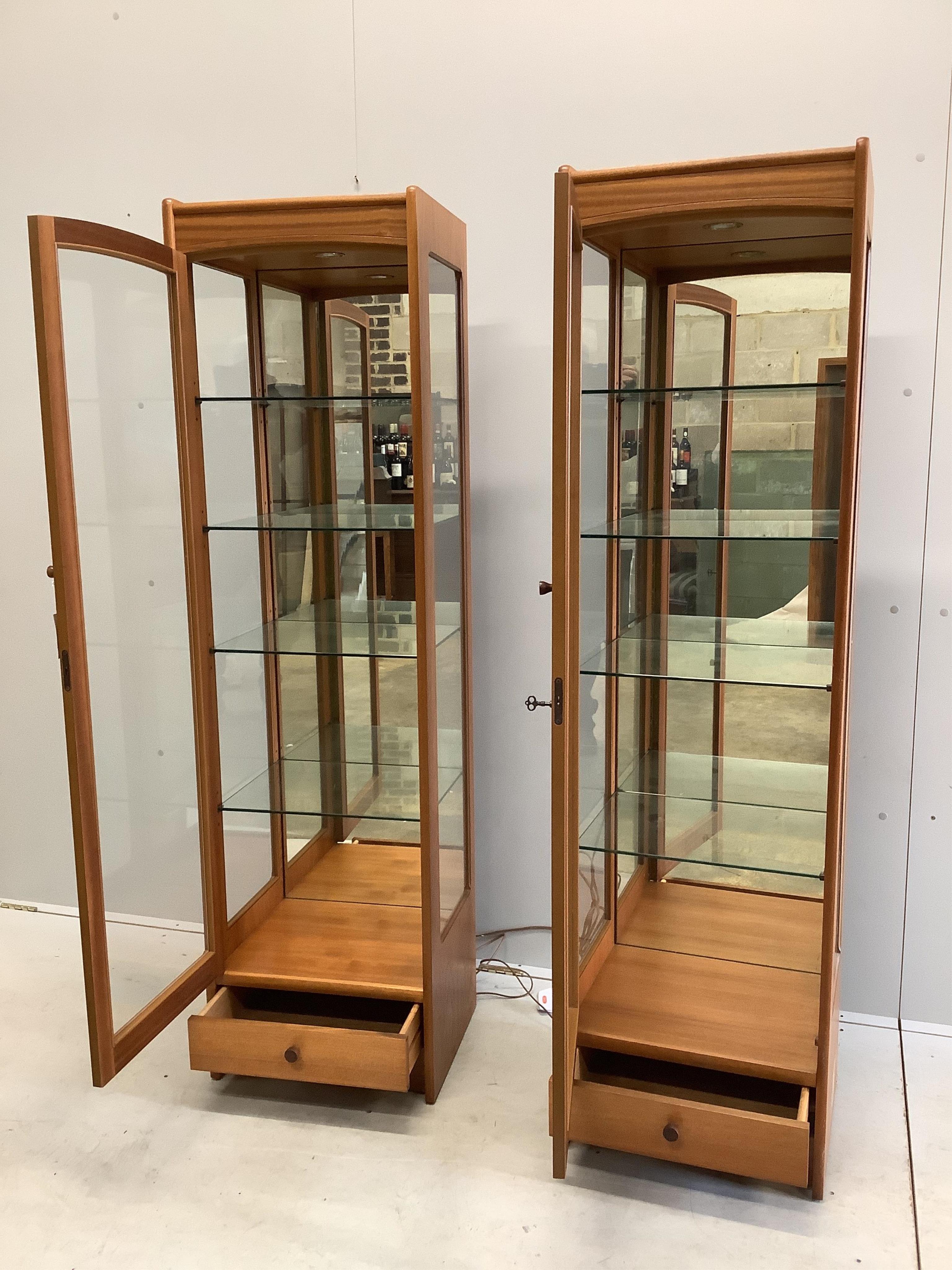 A pair of Parker Knoll teak display cabinets, width 46cm, depth 38cm, height 165cm. Condition - good